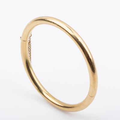 a close up of a gold ring on a white background