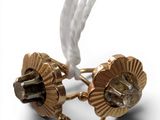 gold plated cuff earrings with a white cord and a white cord