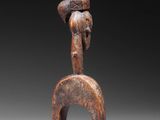 an image of a wooden sculpture of a man with a hat on his head