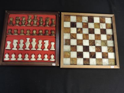 two chess pieces in a wooden box on a black surface