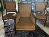 three chairs that are sitting on a rug in a room
