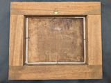 a close up of a wooden picture frame with a black background