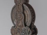 a metal object with a bird on it on a pole