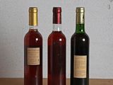 three bottles of wine sitting on a table next to each other