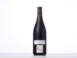 the bottle of wine is sitting on the table with a white background