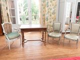 four chairs and a table in a room