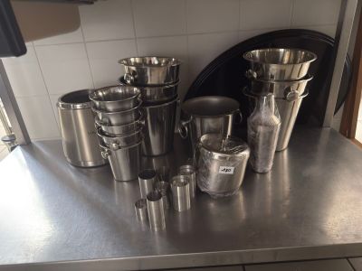 stainless steel counter top with a bunch of cups and cups on it