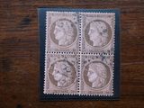 four stamps with heads of women on them sitting on a table