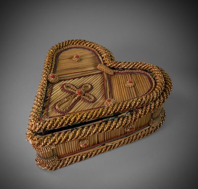 an image of a wicker heart shaped box on a gray background