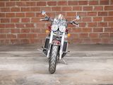 a motorcycle that is parked in front of a brick wall
