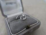 a diamond ring sitting in a ring box on a table
