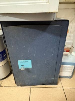 a black box sitting on the floor in the kitchen