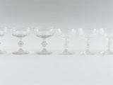 many wine glasses lined up on a table