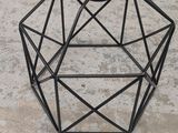 a close up of a candle holder on a concrete surface