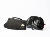 pair of black leather handbags on a white background