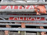 a red sign that says attra on the side of a building