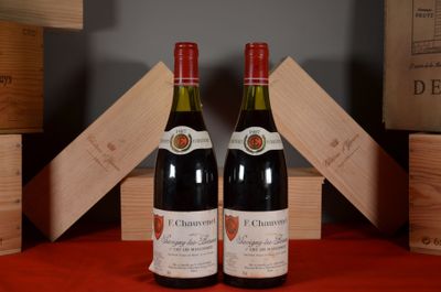 two bottles of wine sitting next to each other on a table