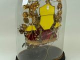 a glass clochet with a picture of a boat inside of it