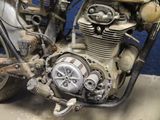 a close up of an old motorcycle with a rusty engine