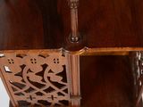 a wooden shelf with a vase on top of it