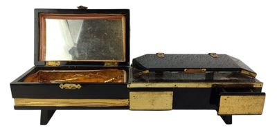 a black and gold vanity with a mirror on it
