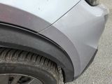 a close up of a car ' s front bumper and tire