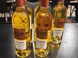 three bottles of wine sitting on top of a table next to each other