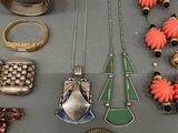 several different types of jewelry are displayed on a table