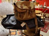 a brown and black bag sitting on top of a chair