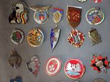 many different types of badges on the wall