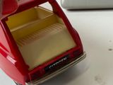 a red toy truck with a yellow tray in the back