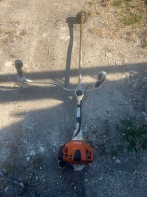 a small lawn mower that is laying on the ground