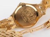 an image of a close up of a gold watch with a chain