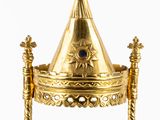 a gold crown with a blue stone on top of it