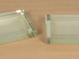 pair of clear glass coasters on a wooden surface