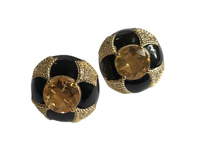 paire de boucles d'oreilles noires et dorées ornées d'un cristal jaune au centre