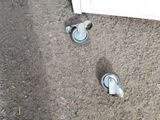two wheels that are sitting on the ground next to a door