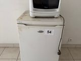 a small refrigerator with a microwave on top of it