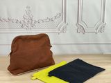 a brown and yellow bag sitting on top of a wooden table