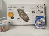 a box with a baby cradler and other items on the shelf