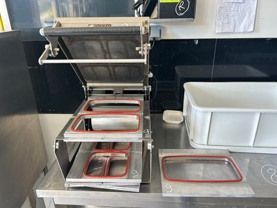 several trays of food sit on top of a table in a kitchen
