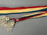 an image of a red, yellow, and blue scarf with tassels