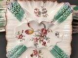 a plate with a bird on it sitting on top of a stack of plates
