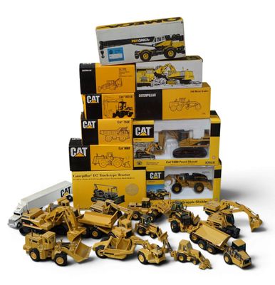 a lot of construction vehicles that are in a pile