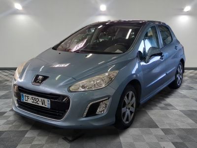 the small blue car is parked in a large room