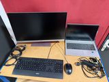 a laptop and a monitor on a desk with a keyboard and mouse