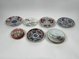 several plates with different designs on them sitting on a table