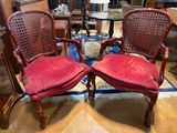 two red chairs in the middle of a living room