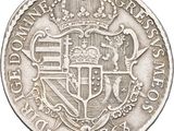 a close up of a silver coin with a crown on it