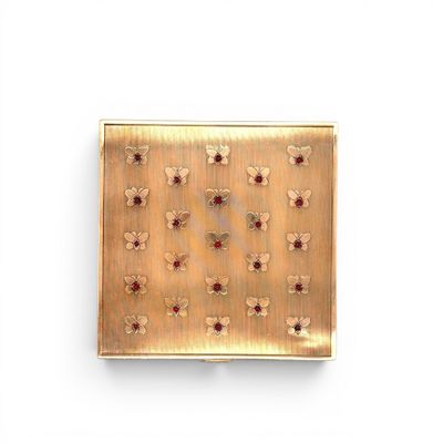 gold plate with red and white flowers on it on a white surface